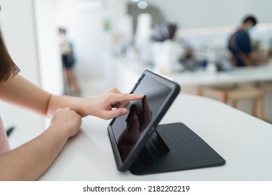 Woman Hand Touch Screen On Digital Tablet While Working In The Coffee Shop. Young Girl Works On The Tablet On The Internet, Ipad Surfing, Woman Using Smartphone, Holding Tablet In Hand