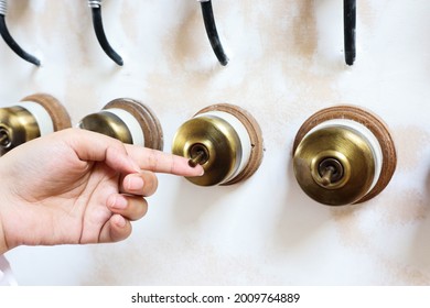 Woman Hand Is Turning On Or Off On Old Light Switch On Wall.