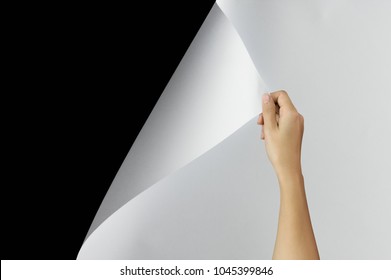 Woman Hand Turning Page Of Paper, Blank Sheet Of Paper On Black Background With Clipping Path. Change Concept.