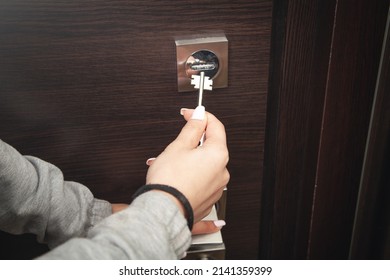 Woman Hand Unlocking Door With Key.