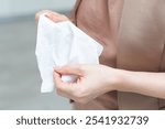 Woman hand use antibacterial wet wipes or tissue isolated on a white background with clipping path. Concept of hygiene and protection from Covid-19