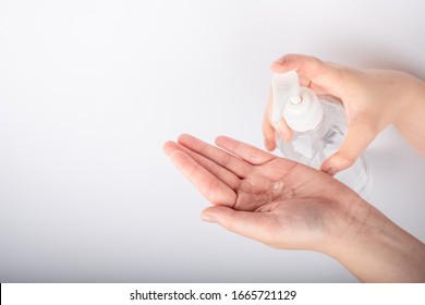 Woman hand using alcohol wash gel for cleaning sanitize gel pump dispenser on white background, health care concept - Shutterstock ID 1665721129