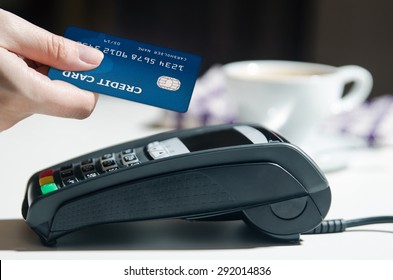 Woman Hand Using Payment Terminal In Restaurant