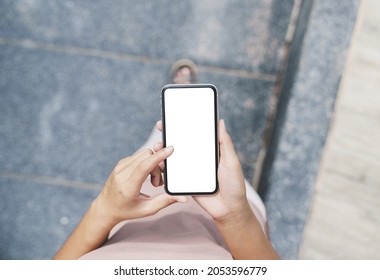 woman hand using phone white blank screen walking on path way