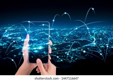 woman hand using smart phone with abstract line connection on night city background - Shutterstock ID 1447116647