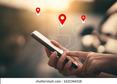 Woman hand using smartphone with gps navigator map icon on blur street background. Technology lifestyle and business travel concept. Vintage filter effect color style.