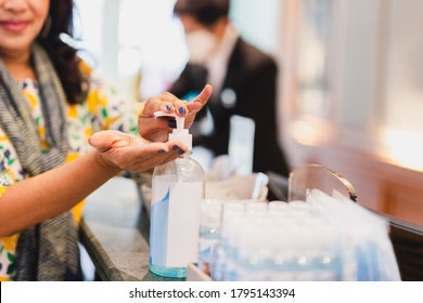 Woman Hand Washing Alcohol Gel In Hotel Front Desk For Stop Covid 19 Spread