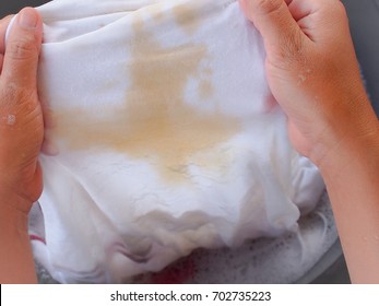 Woman Hand Washing Clothes With Coffee Stains.