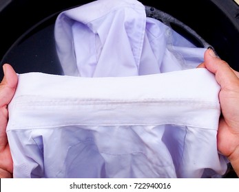 Woman Hand Washing  Clothes With  Dirty Sweat Stains On White  Shirt.