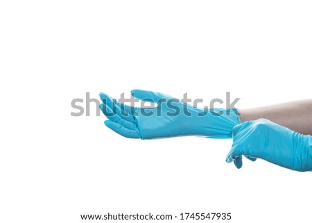 Woman hand  wearing a blue rubber medical glove on white isolated background.