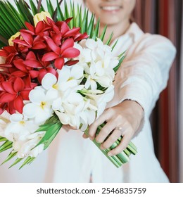 Woman hand wearing a diamond ring and holding flower bouquet. Idea for marriage proposal, romantic surprise, wedding, engagement and valentines day concept - Powered by Shutterstock