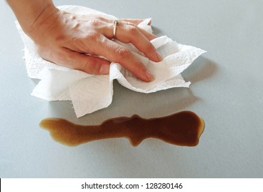 Woman Hand Wiping Spilled Coffee With Paper Towel