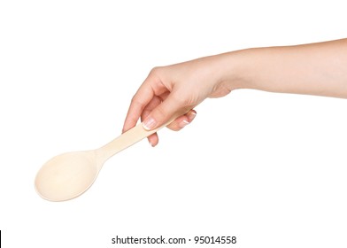 Woman Hand With Wooden Spoon Isolated On White Background