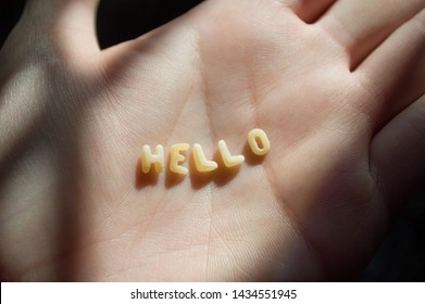 Woman Hand With The Word Hello Made With Word Sopa, Means Soup, Letters Of Alphabet Of Pasta For Kids Soup Food