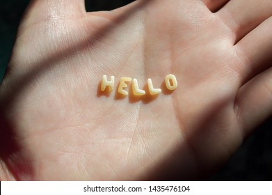 Woman Hand With The Word Hello Made With Word Sopa, Means Soup, Letters Of Alphabet Of Pasta For Kids Soup Food