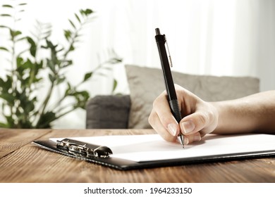 Woman Hand Writing And Office Interior. 