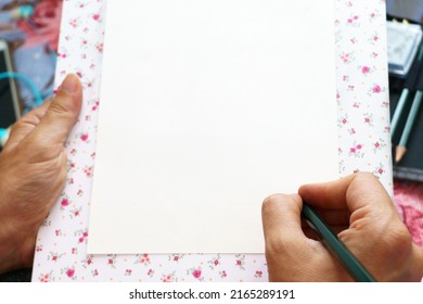 Woman Hand Writing On Empty White Paper With A Pencil. Copy Space For Advertising Texts.