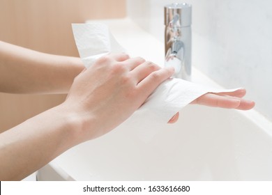 Woman Hands Being Dried With Tissue Paper