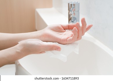 Woman Hands Being Dried With Tissue Paper