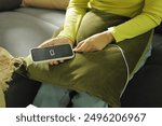 Woman hands Charging mobile phone battery with low battery. plugging a charger in a smart phone  with energy bank powerbank power charger Modern lifestyle energy technology concept