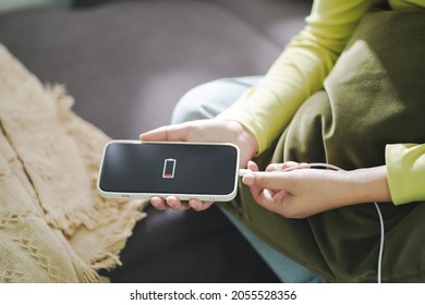 Woman Hands Charging Mobile Phone Battery With Low Battery. Plugging A Charger In A Smart Phone  with Energy Bank Powerbank Power Charger Modern Lifestyle Energy Technology Concept