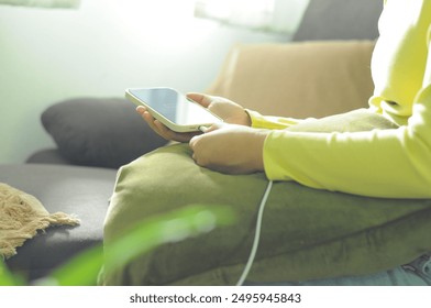 Woman hands Charging mobile phone battery with low battery. plugging a charger in a smart phone  with energy bank powerbank power charger Modern lifestyle energy technology concept - Powered by Shutterstock