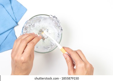 Woman Hands Cleaning Silver Jewelry At Home. Top View