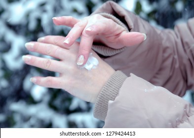 Woman Hands Close Up, Applying Skin Cream, Protecting From Cold Weather On Winter Season. Take Care Of Dry Skin Outdoors In Snowy Nature