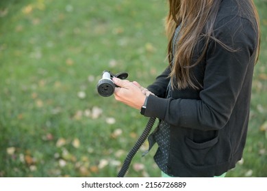 Woman Hands Connecting Black Garden Hose And Spray Nozzle Medium Tight Shot