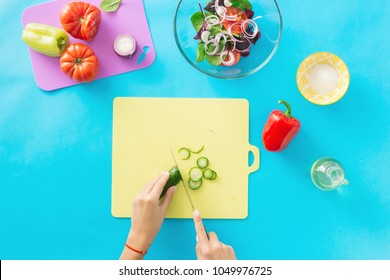 Woman Hands Cooking A Summer Vegetarian Salad On A Blue Background. Healthy Food Concept. Diet Food