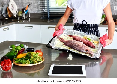 Woman Hands Cooking Trout Fish In Domestic Kitchen.