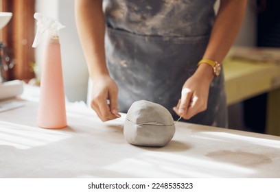 Woman, hands and cut clay in pottery studio, workshop and creative startup for sculpture product. Ceramic artist, wire cutter and process for production, manufacturing and designer in small business - Powered by Shutterstock