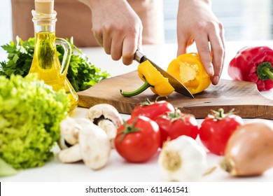 Woman hands cutting vegetables in the kitchen