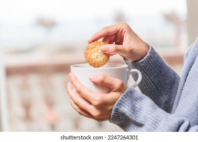 Woman hands dipping cookie into coffee cup	 - Powered by Shutterstock