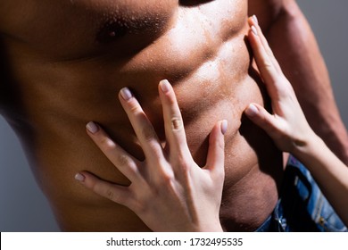 Woman Hands Embracing Sexy Man Six Pack Abs. Close Up Of Muscle Man Torso. Passionate Couple. Hot Brunette Woman And Handsome Muscular Man In Bedroom