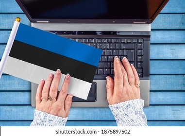 Woman Hands And Flag Of Estonia On Computer, Laptop Keyboard 