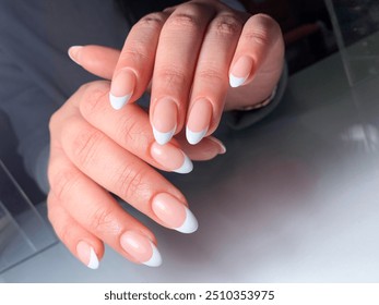 Woman with hands French white nails design. Manicure. Nail salon. Basic Nail. Hands. Party. Luxury. Classic bridal nail design. French Nails