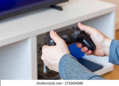 Woman hands with a game controller, relaxation at home,  closeup