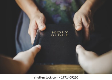 Woman hands giving Bible and evangelizing someone,Gospel