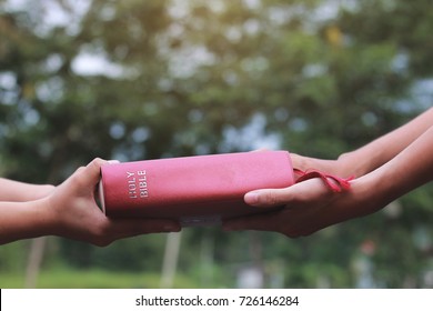 Woman hands giving Bible and evangelizing someone,Gospel 