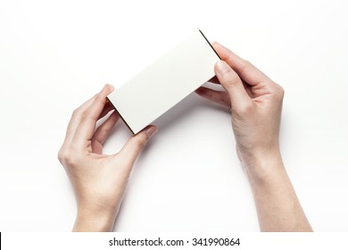 A Woman Hands Hold A Empty(blank, Vacant, Hollow) White Paper Box(package) For Cosmetics, Accessory, Top View Isolated White At The Studio.