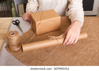 Woman Hands Hold Finish Decorating Present. Eco Gift Wrapping On Table. Decorating Gift With Nature Materials, Do It Yourself