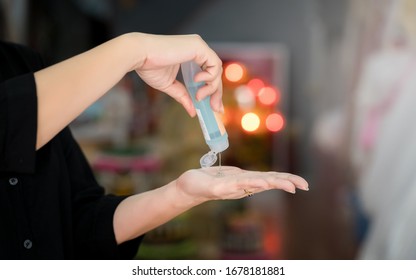 Woman hands is  holding  alchol jel bottle  for hand washing  and kill virus germs Coronavirus . (COVID-19). Anti-virus 