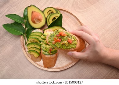 Woman Hands Holding Avocado Toast. Healthy Food Concept.