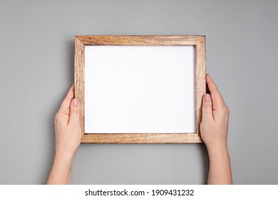 Woman Hands Holding Blank Wooden Frame . Mockup, Template, Copy Space