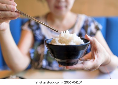 Woman Hands Holding Bowl Of Tasty Cooked White Rice