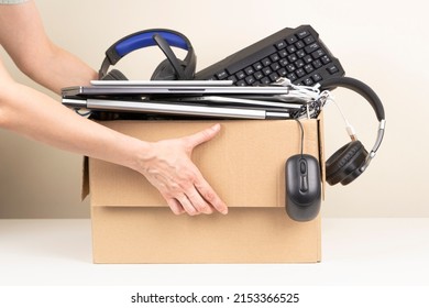 Woman hands holding cardboard box full old used computers, phones, tablets, gadget devices for recycling. Planned obsolescence, e-waste, donation, electronic waste for reuse and recycle concept - Shutterstock ID 2153366525