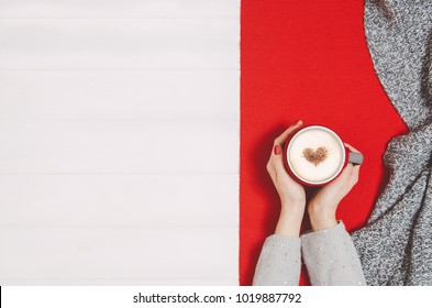 Woman Hands Holding Coffee Mug Or Cup On White Wooden Table. Photograph Taken From Above, Top View With Copy Space