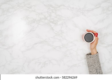 Woman Hands Holding Coffee Mug Or Cup On Colorful Table. Photograph Taken From Above, Top View With Copy Space