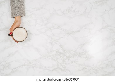 Woman Hands Holding Coffee Mug Or Cup On Colorful Table. Photograph Taken From Above, Top View With Copy Space